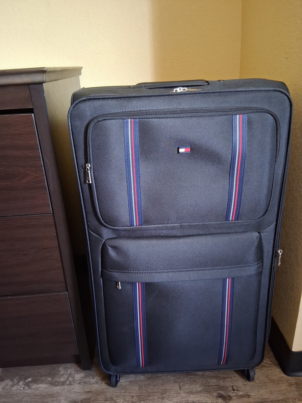 Tommy Hilfiger Black Roller Suitcase with Red & Blue Stripe Accents